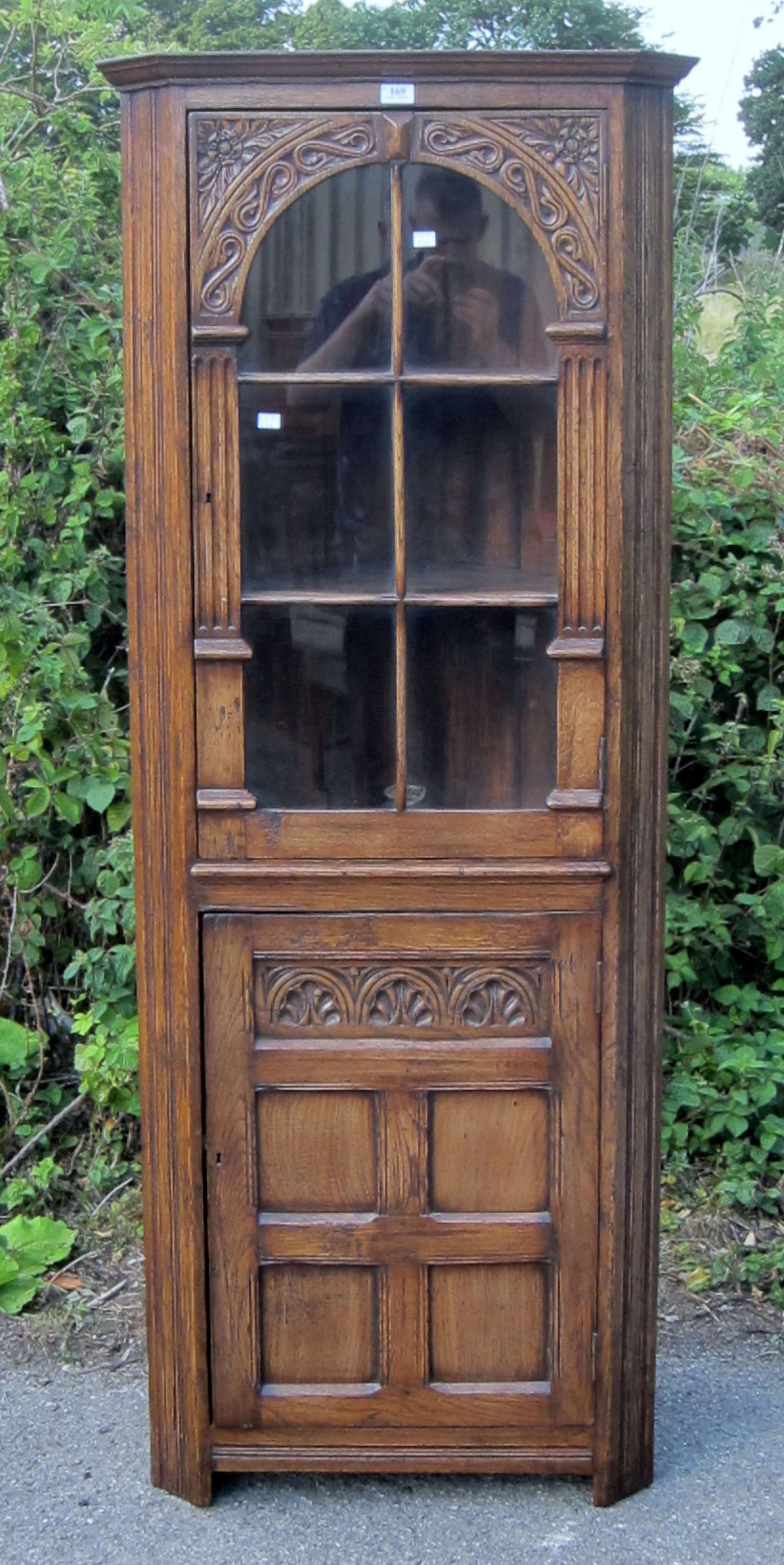 Appraisal: Oak corner cabinet with glazed door above cupboard door