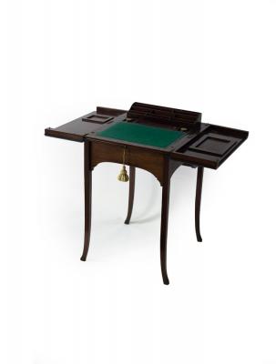 Appraisal: An Edwardian mahogany writing table the hinged top concealing a