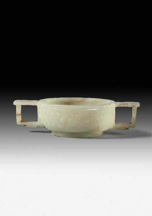 Appraisal: A Chinese celadon green jade two-handled vessel carved with stylised