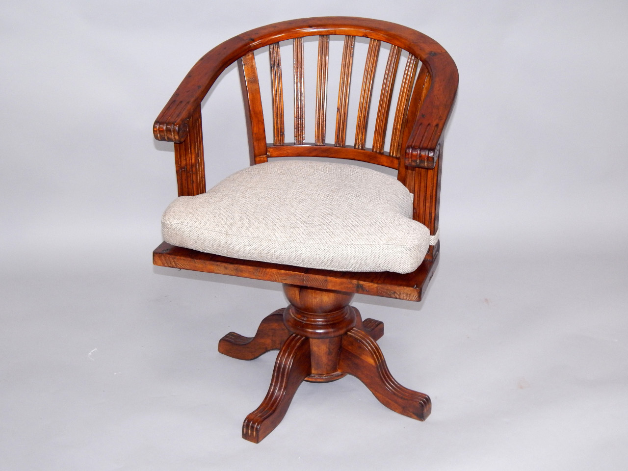 Appraisal: A stained pine captain's chair raised on turned column and