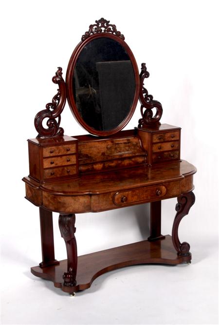 Appraisal: A Victorian walnut dressing table the oval mirror on scroll