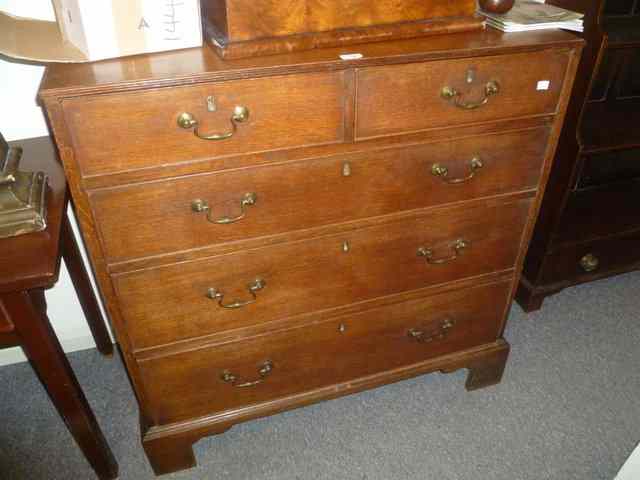 Appraisal: A GEORGIAN OAK CHEST of three long two short drawers