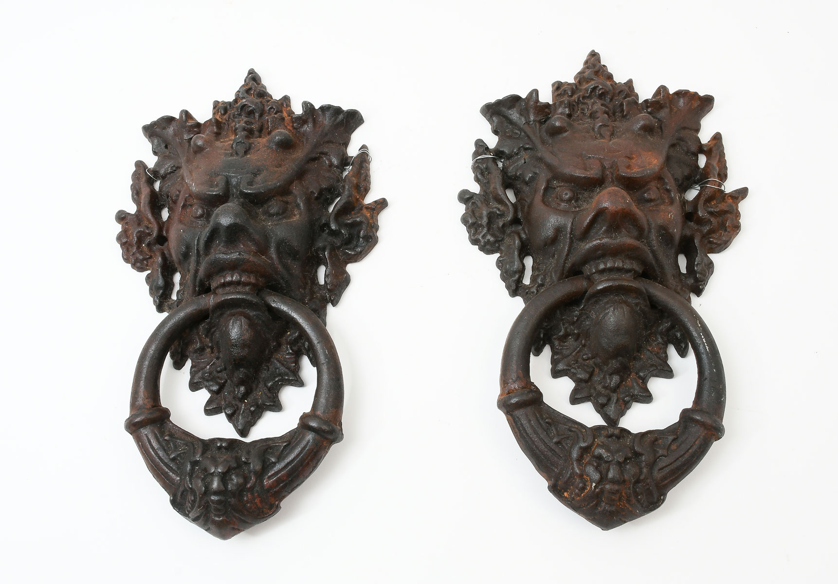 Appraisal: PAIR OF CAST IRON GARGOYLE DOOR KNOCKERS cast iron door