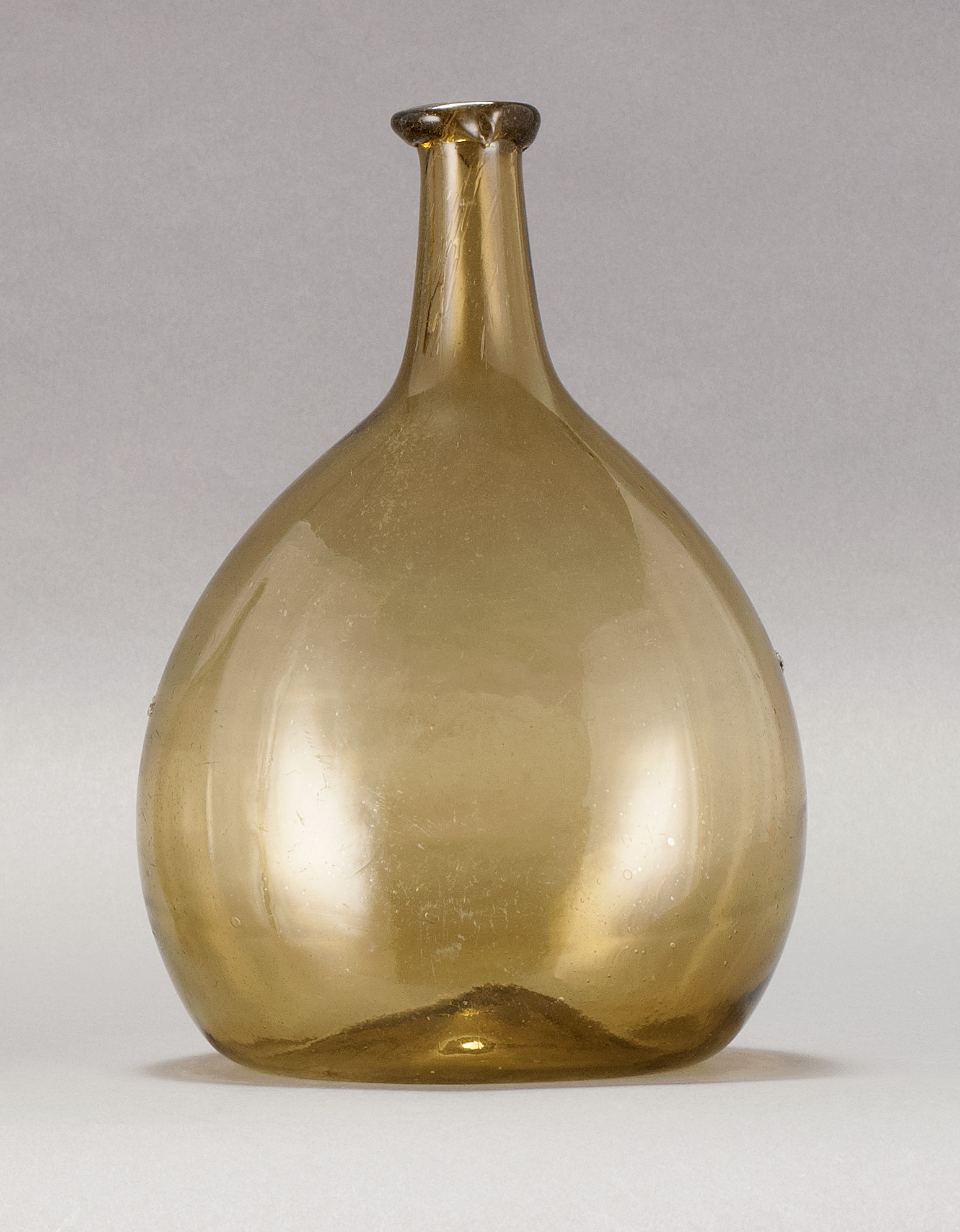 Appraisal: FREE-BLOWN GLASS CHESTNUT FLASK Early th CenturyIn amber Height From