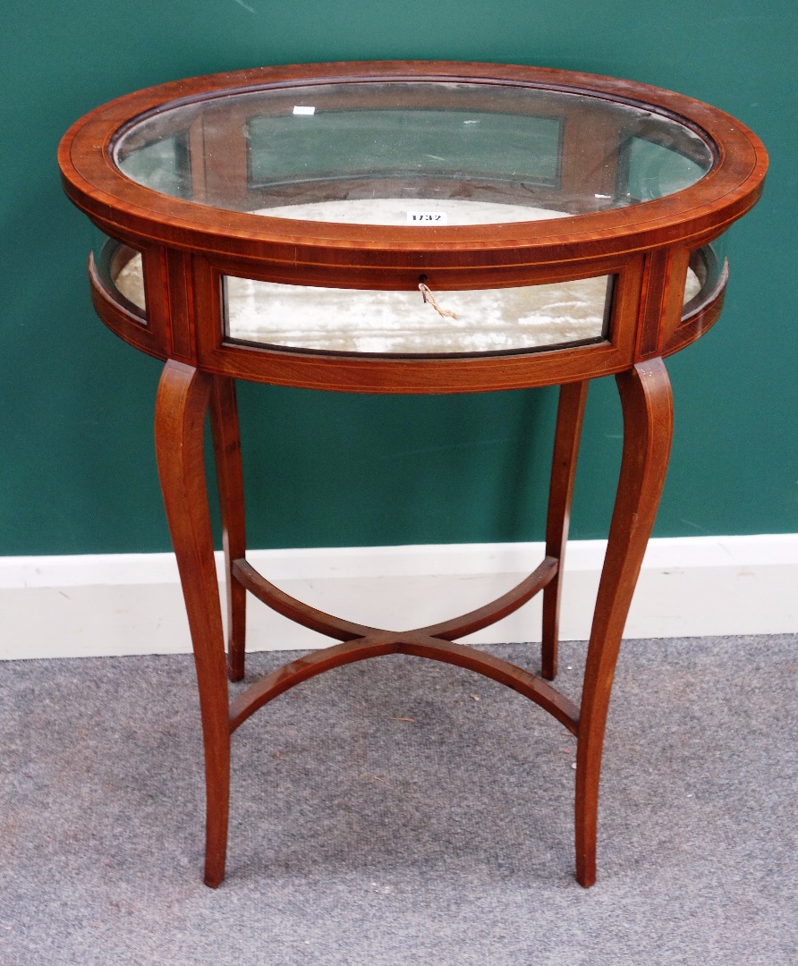 Appraisal: A late th century satinwood banded mahogany oval bijouterie table