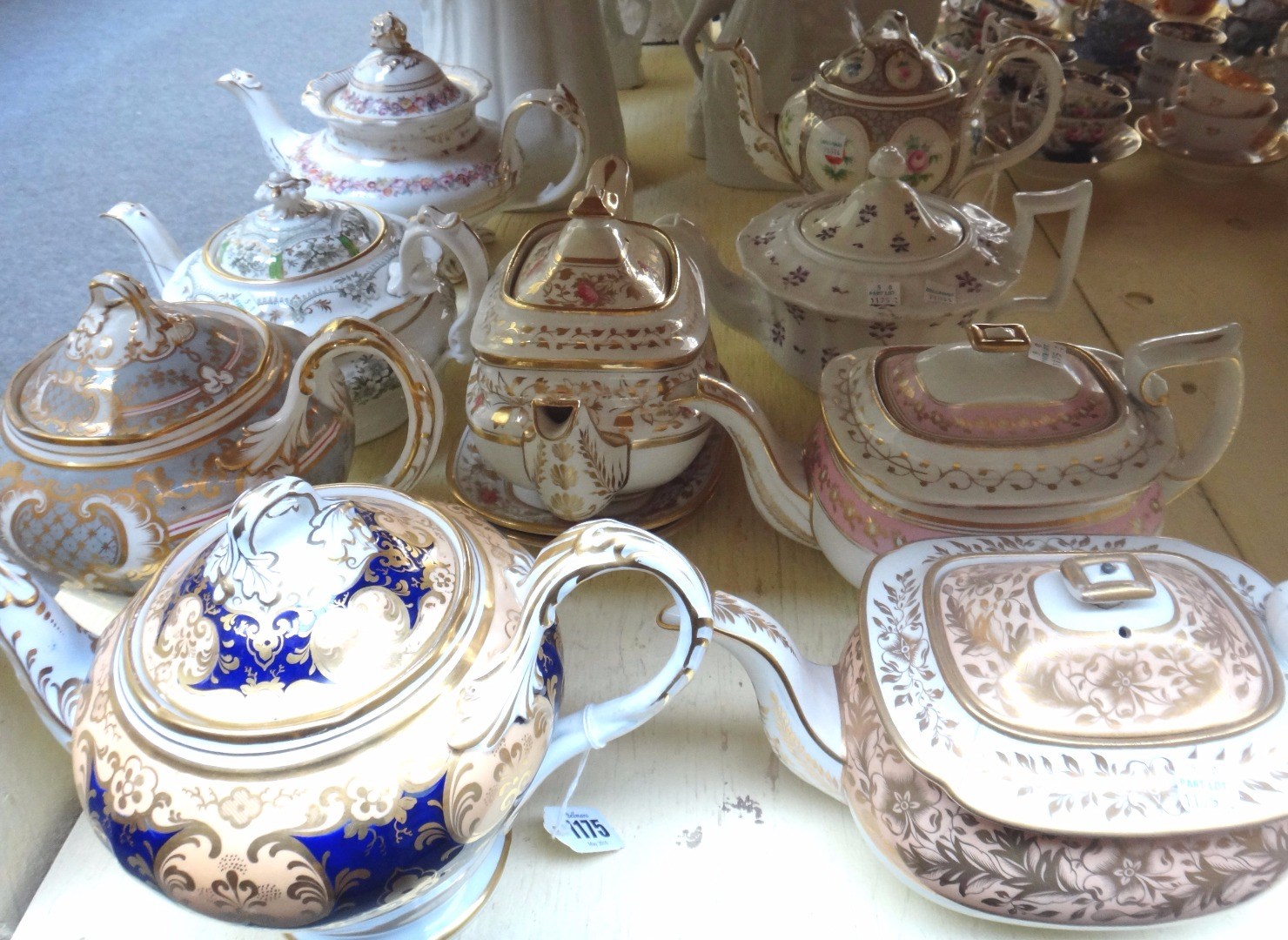 Appraisal: A group of nine English porcelain teapots and covers and