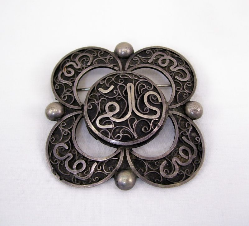 Appraisal: Asiatic Style Pin Silvertone pin with Asiatic stylings Measures across