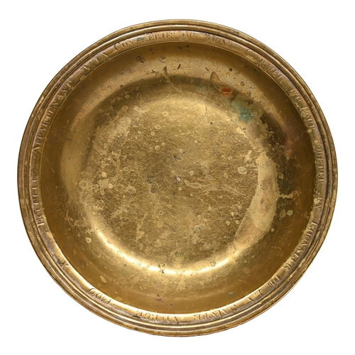 Appraisal: A French silvered brass alms dish dated engraved within the