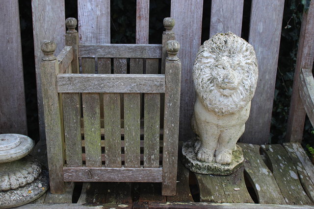 Appraisal: A RECONSTITUTED STONE SCULPTURE in the form of a lion