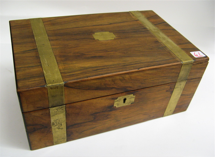 Appraisal: HARDWOOD STATIONERY BOX brass banded opening to reveal slots for