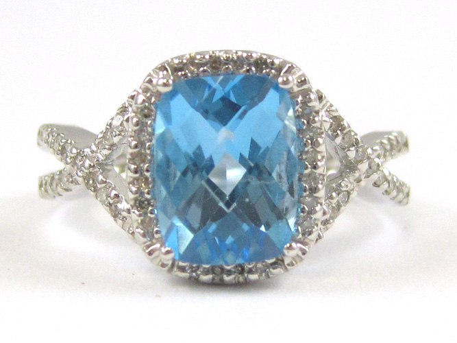 Appraisal: BLUE TOPAZ AND FOURTEEN KARAT WHITE GOLD RING with round-cut