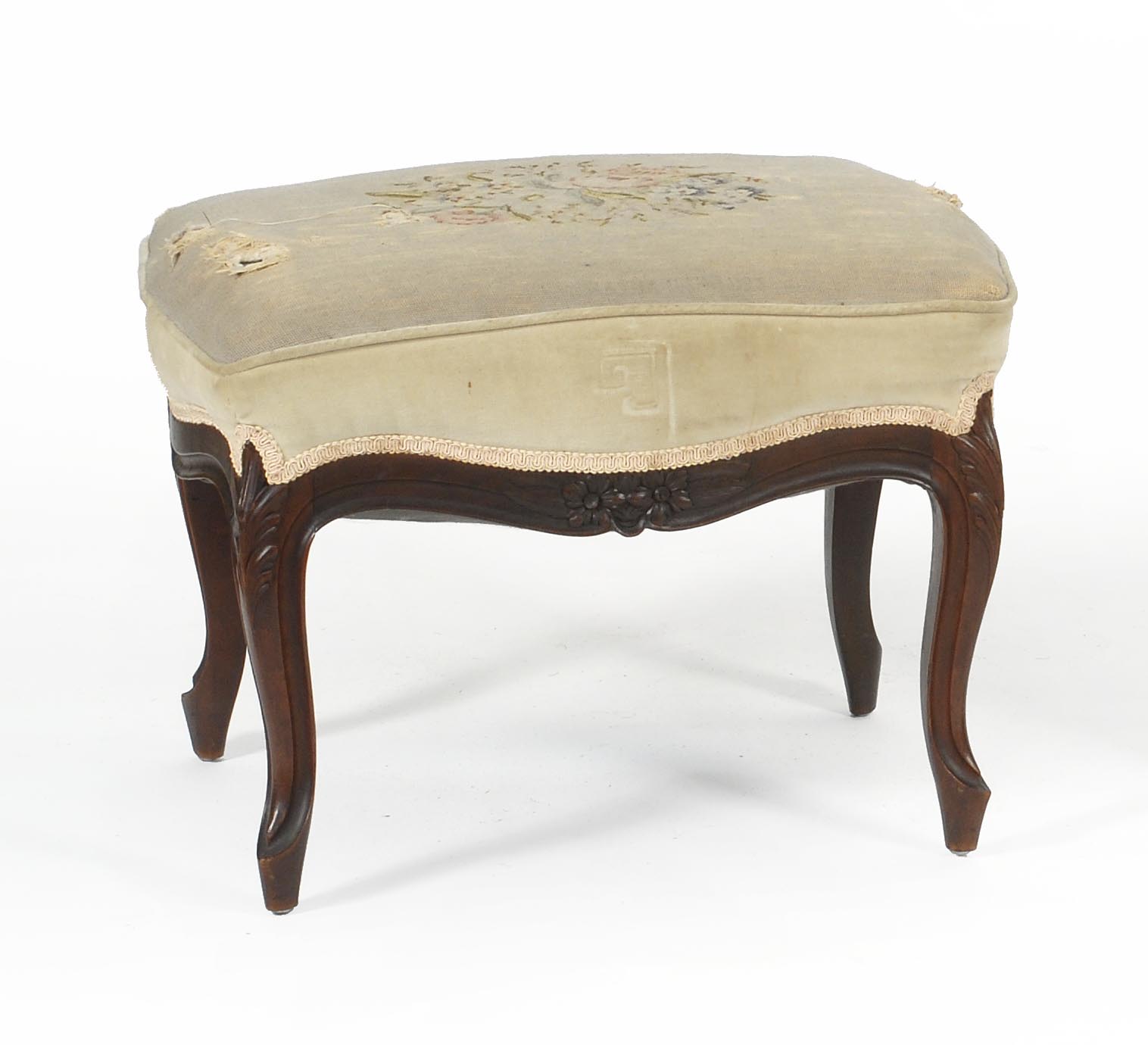 Appraisal: VICTORIAN FOOTSTOOL with floral and foliate-carved walnut frame Needlepoint seat