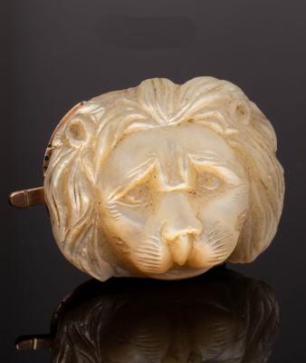 Appraisal: A carved mother-of-pearl lion mask mounted as a clasp cm