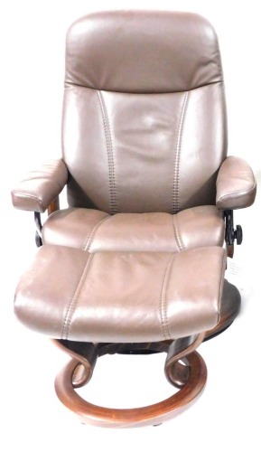 Appraisal: A Stressless brown leather single reclining armchair and footstool with