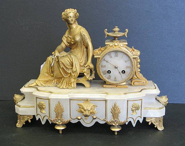 Appraisal: A French gilt metal and white onyx figural mantel clock