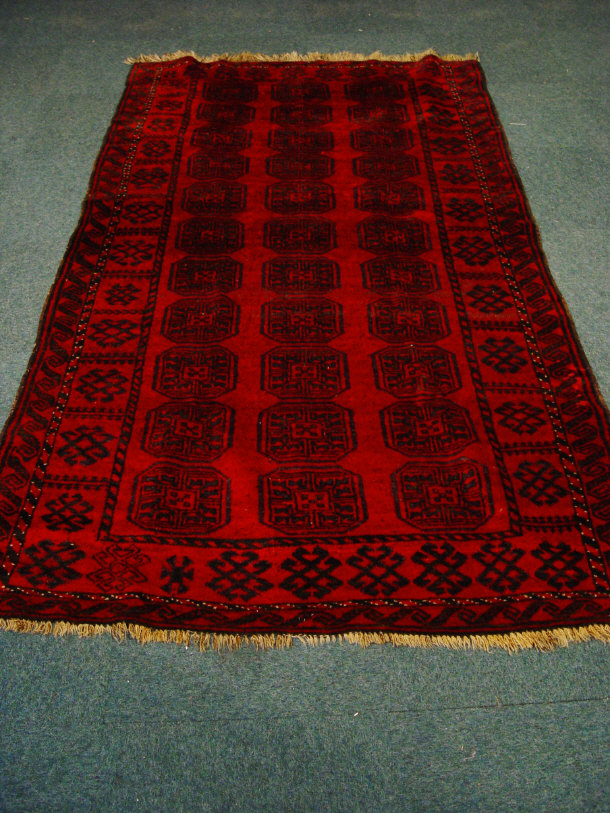 Appraisal: Red ground rectangular rug with black geometric decoration cm x