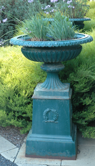 Appraisal: A PAIR OF REGENCY STYLE CAST IRON URNS ON PEDESTALS