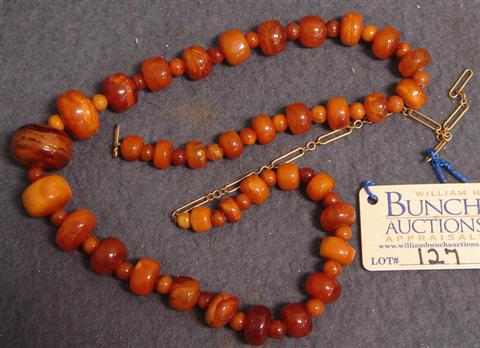 Appraisal: Amber colored graduated necklace YG link catch long Estimate -