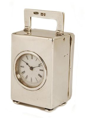 Appraisal: A silver cased miniature clock with a French movement with