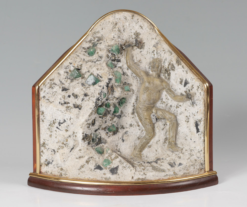 Appraisal: COLUMBIAN EMERALD SCULPTURE Raw emeralds in mineral aggregate with carved