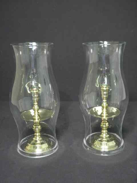 Appraisal: Pair of solid brass colonial style hurricane candlesticks Made by