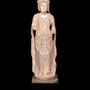 Appraisal: A Chinese Carved Sandstone Buddha with Remnants of Polychrome Decoration