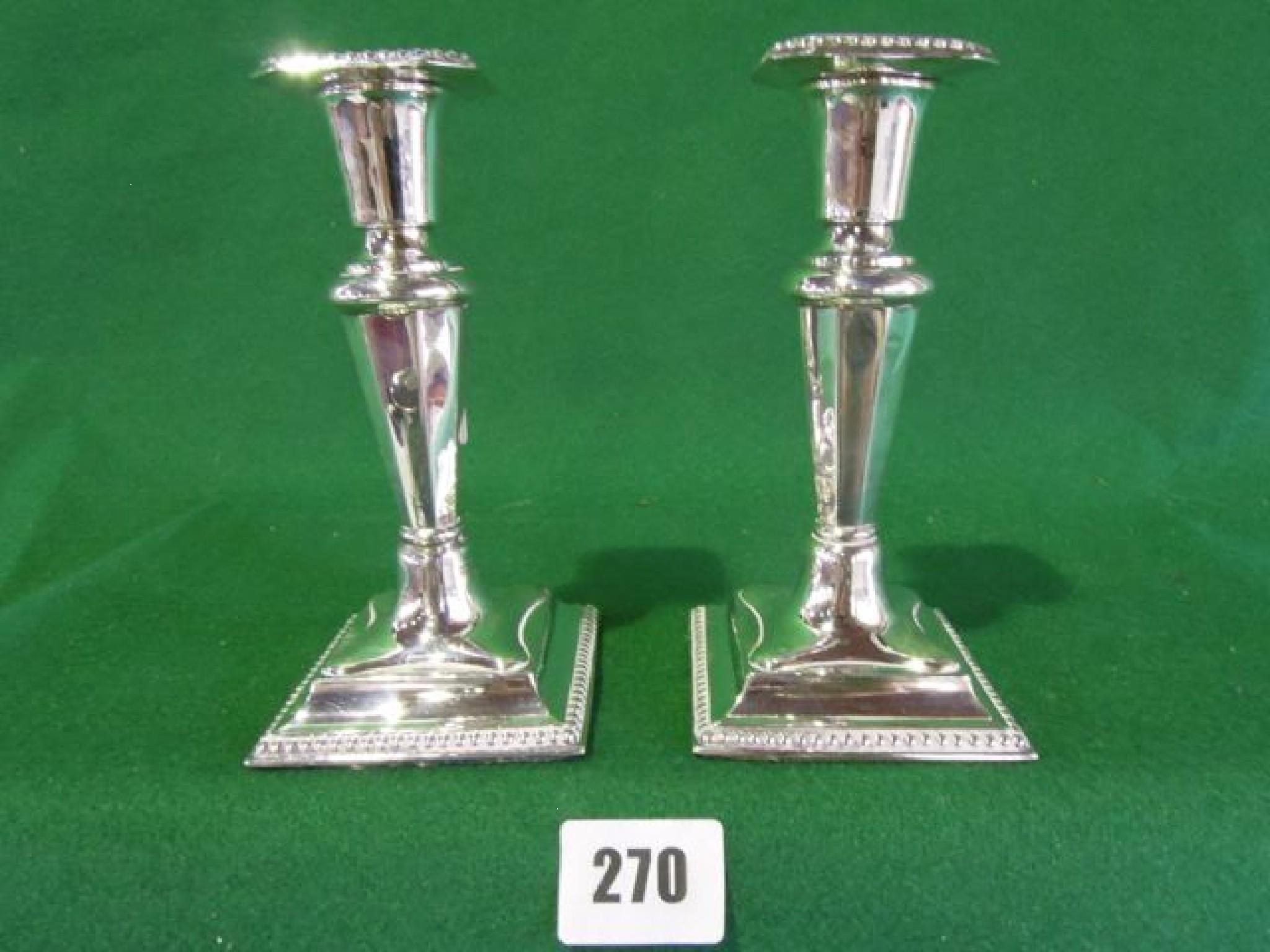 Appraisal: A pair of silver candlesticks in the Adam's style with