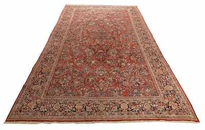 Appraisal: A Large Persian Sarouk Carpet Red ground with overall floral