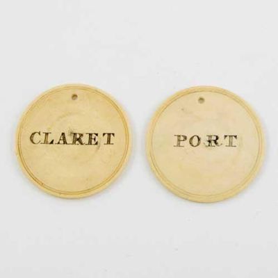 Appraisal: A pair of George III ivory disc wine labels PORT