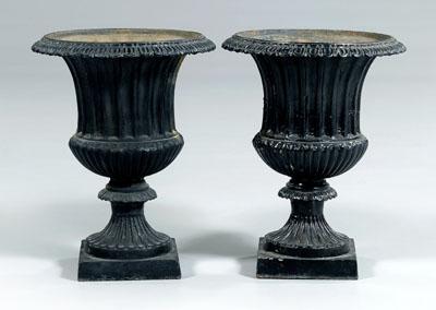 Appraisal: Pair black-painted cast iron urns typical form with fluted bodies