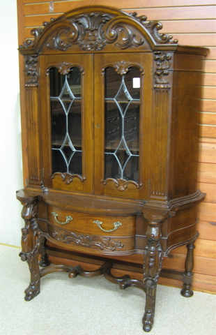 Appraisal: LATE JACOBEAN STYLE CARVED WALNUT CHINA CABINET ON STAND American