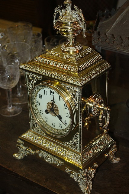 Appraisal: A VICTORIAN BRASS STRIKING MANTEL CLOCK with urn finial and