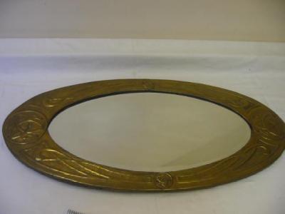 Appraisal: AN ARTS AND CRAFTS BRASS WALL MIRROR of oval form