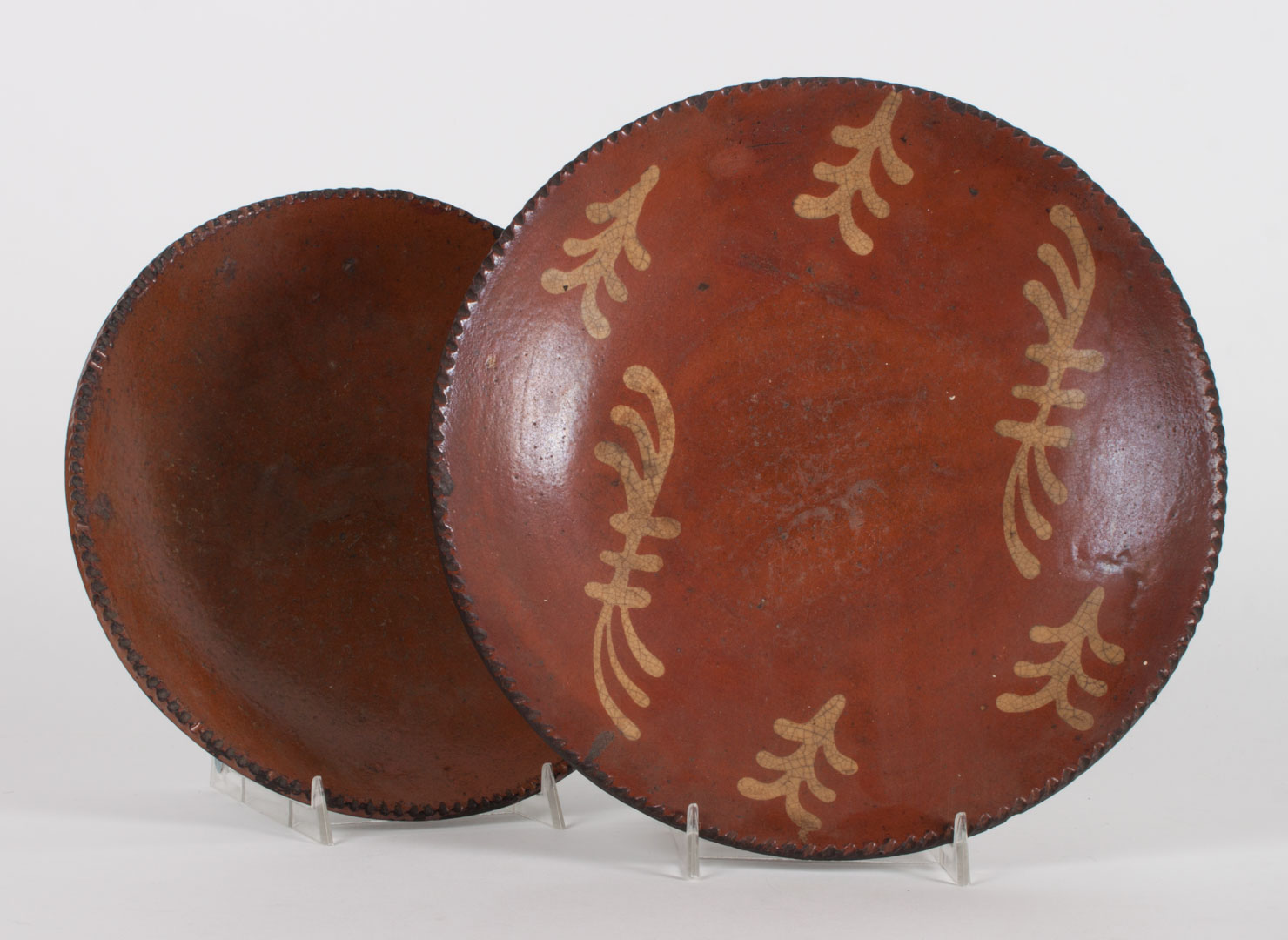 Appraisal: Two American redware pottery plates mid- th century both with