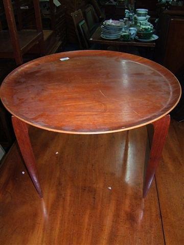 Appraisal: A Danish hardwood circular tray-topped table with folding stand of