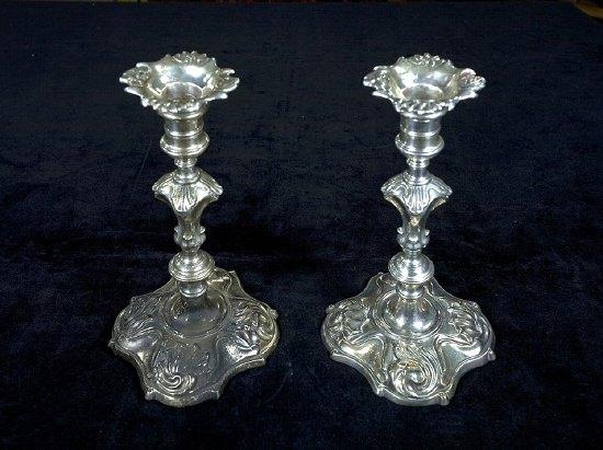 Appraisal: A pair of George II cast candlesticks crested on baluster