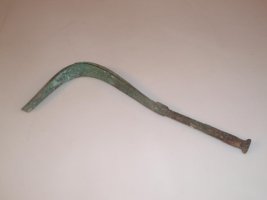 Appraisal: A Roman bronze strigil with a curved grooved scraper broken