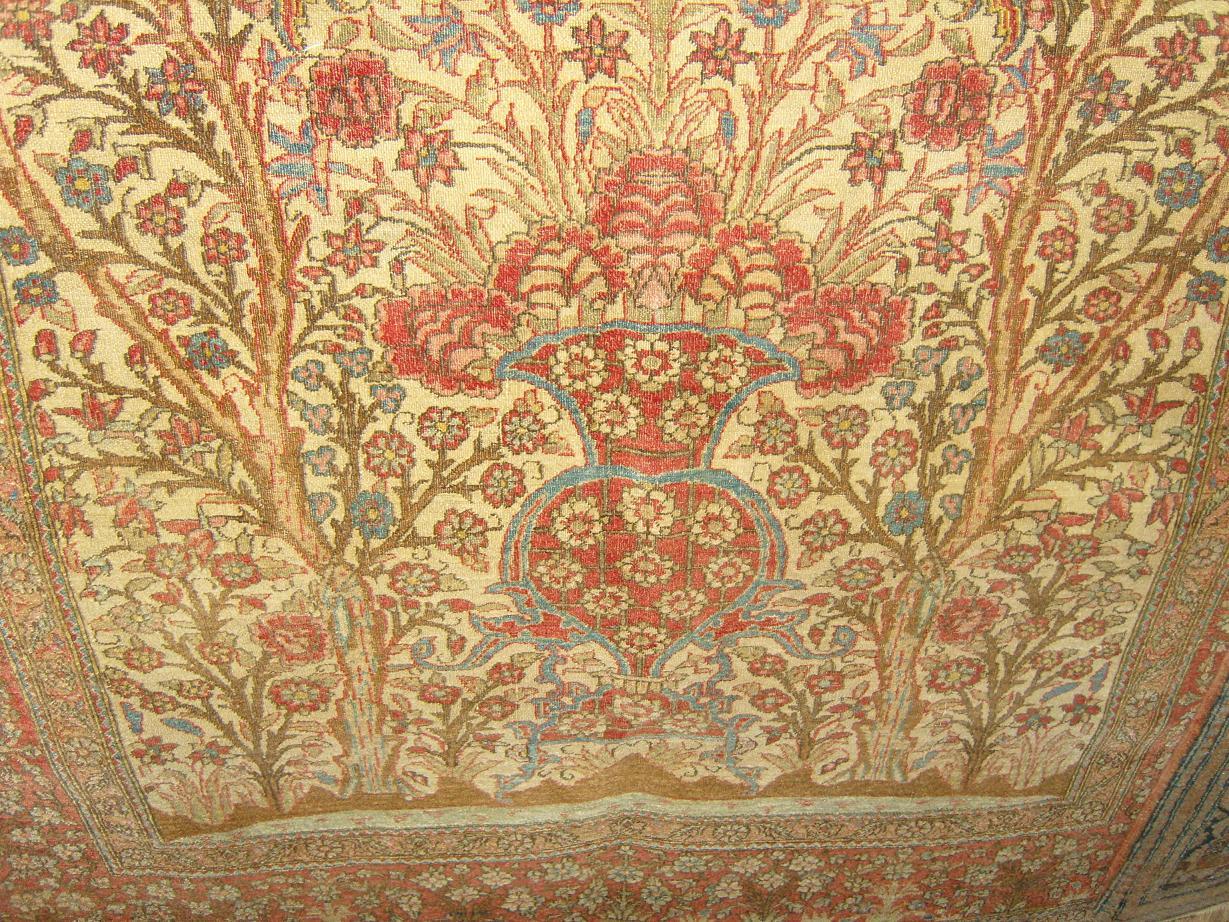 Appraisal: A cream ground eastern silk rug with flowering tree decoration