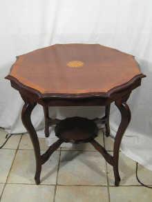 Appraisal: An Edwardian mahogany shaped octagonal table on four legs with