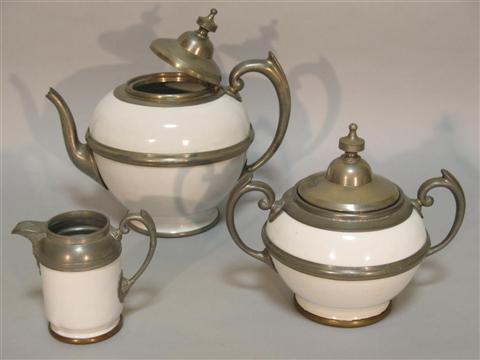 Appraisal: CONTINENTAL METAL MOUNTED STONEWARE TEA SERVICE Including a teapot and