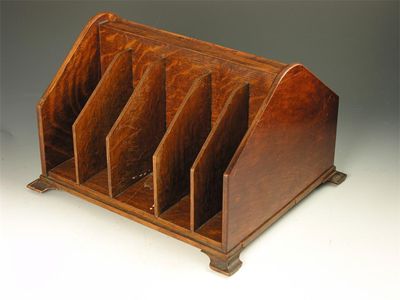 Appraisal: An oak revolving desk stand one side with stationary compartments