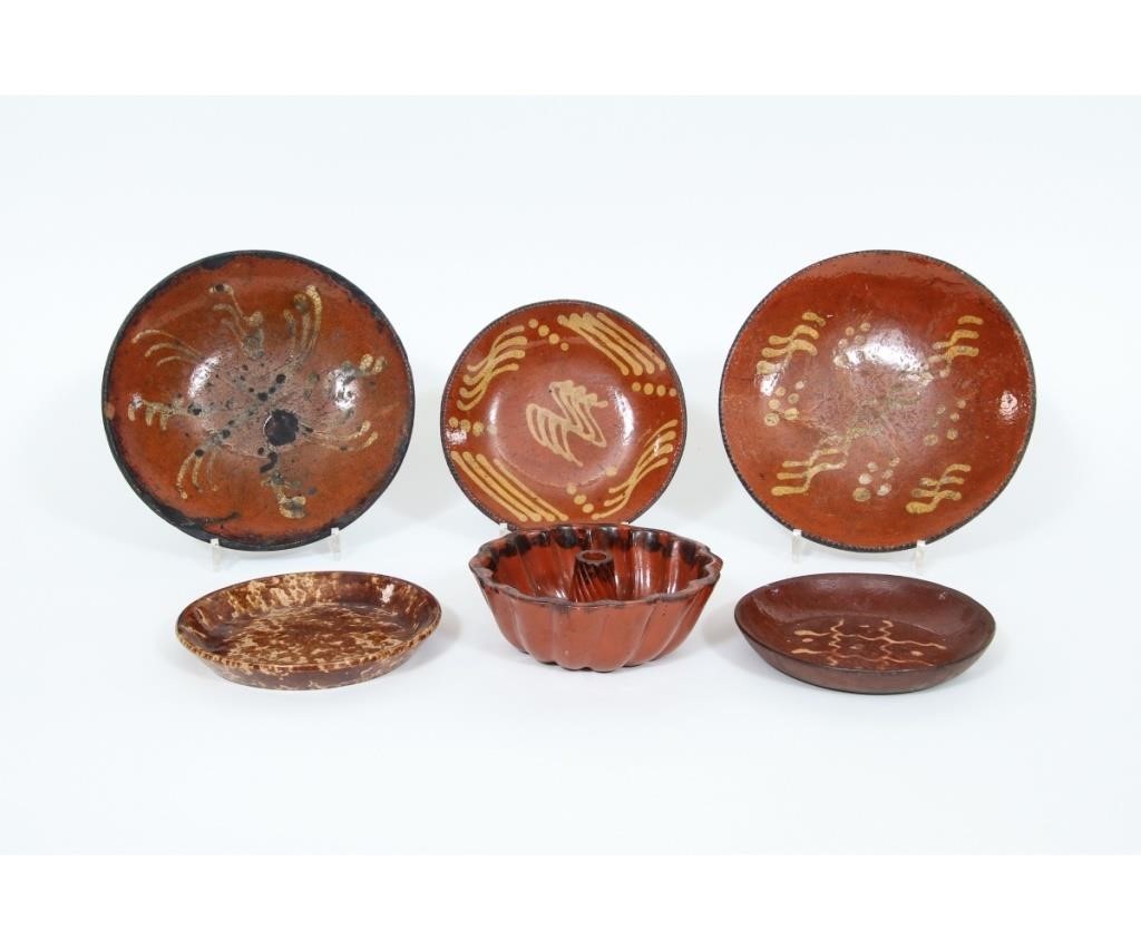 Appraisal: Four redware pie plates with slip decoration th c largest