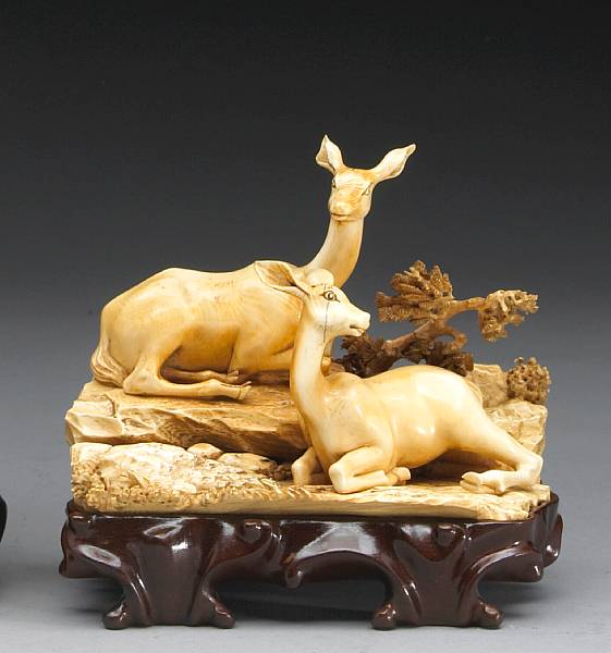 Appraisal: A tinted and carved ivory figural group of deer Naturalistically