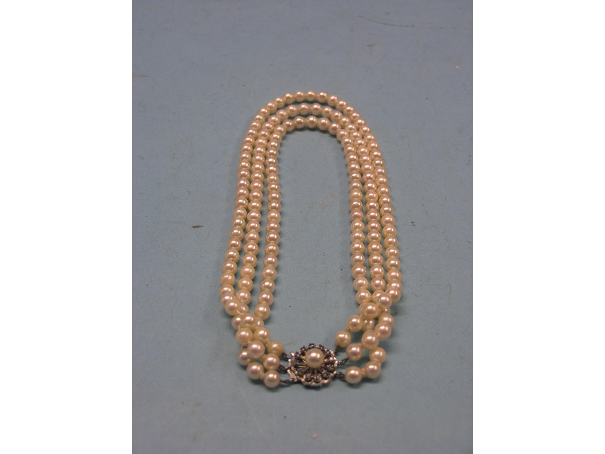 Appraisal: A three-row cultured pearl necklace ct white gold mount set