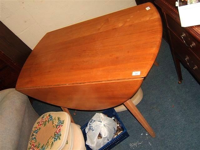 Appraisal: An Ercol light elm kitchen table with drop leaves and