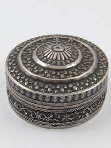 Appraisal: A white metal tests silver circular box with stepped dome