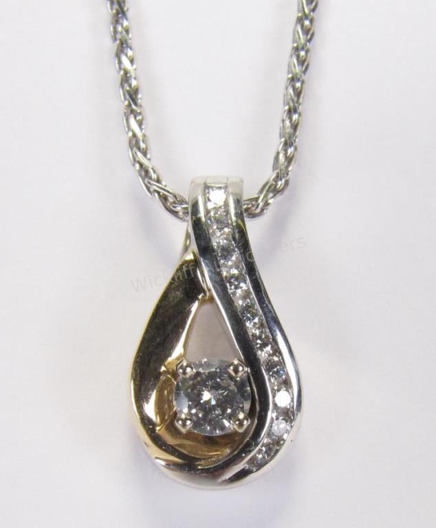 Appraisal: A K white and yellow gold pear shaped pendant with