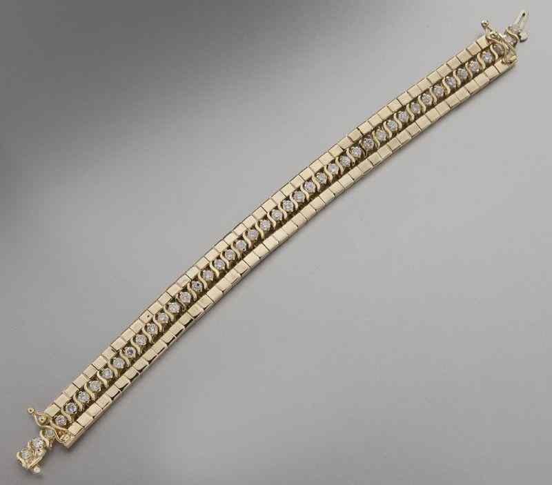 Appraisal: K gold and diamond tennis bracelet with jacketfeaturing round brilliant