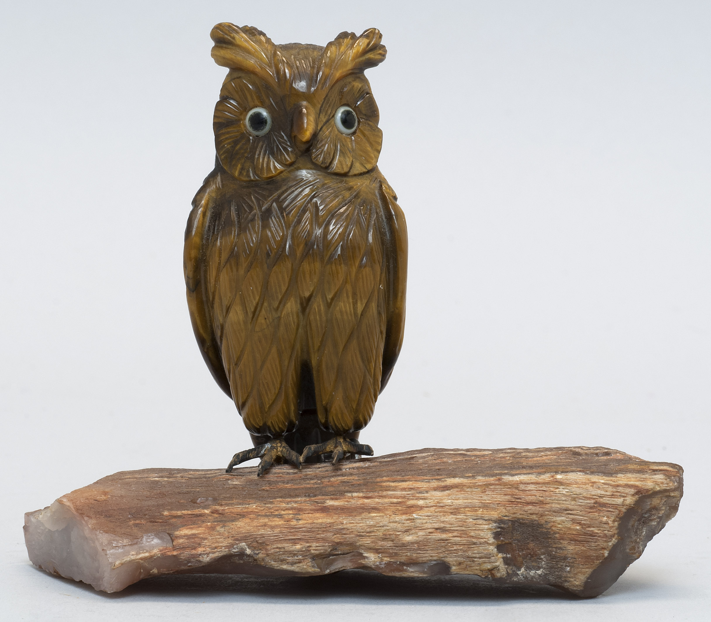 Appraisal: CARVED TIGER'S EYE OWL th CenturyMounted on a quartz base