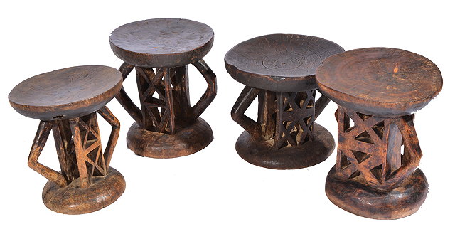 Appraisal: FOUR AFRICAN CARVED HARDWOOD STOOLS with dished topped and pierced